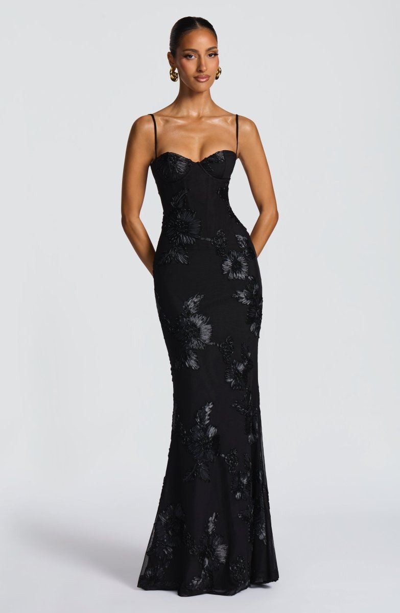 Woman wearing floral embroidered lace bustier maxi dress, front view