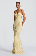 Side pose showing dress silhouette and flow