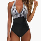 Swimsuit on model, beach setting, relaxed pose
