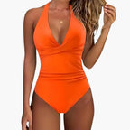Model posing in swimsuit at poolside, full body shot