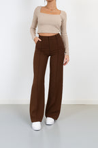 Back view of high waisted wide leg trousers on model
