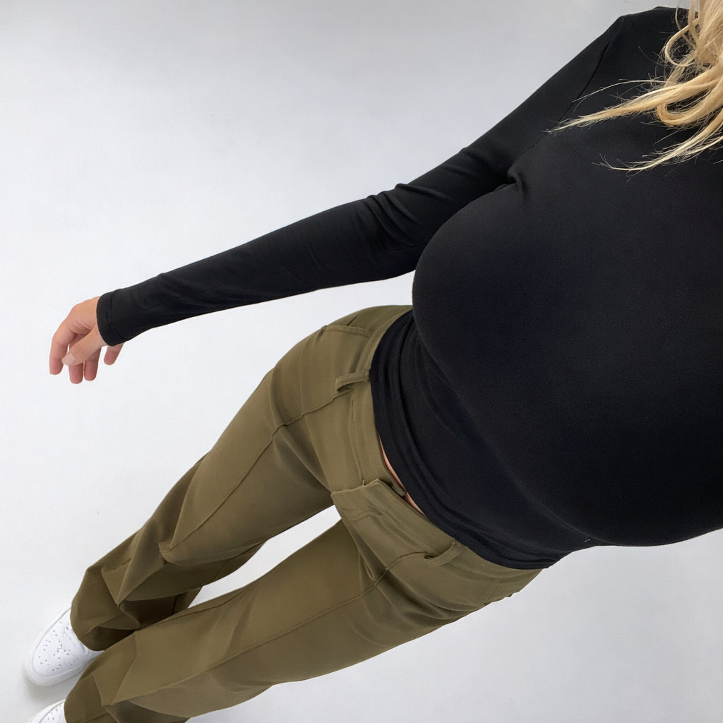 Model walking in high waisted wide leg trousers