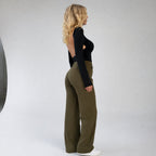Side profile of model in high waisted wide leg trousers