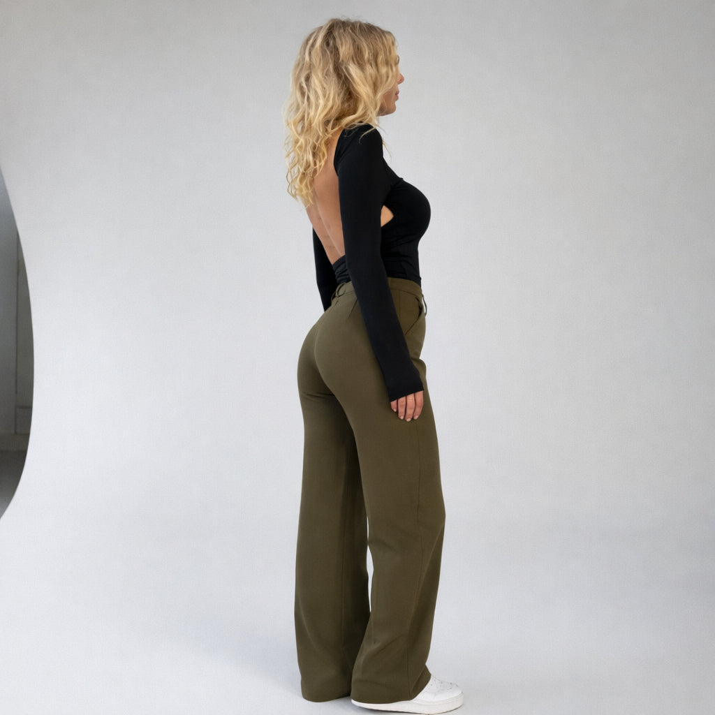 Side profile of model in high waisted wide leg trousers