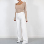 Model wearing high waisted wide leg trousers, standing pose