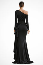 Model wearing black maxi dress, side profile showing dramatic slit