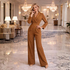 Model wearing black blazer jumpsuit, standing pose showing full silhouette
