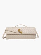 Gold-tone button fastening detail on clutch
