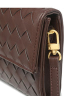 Clutch bag in hand, three-quarter view