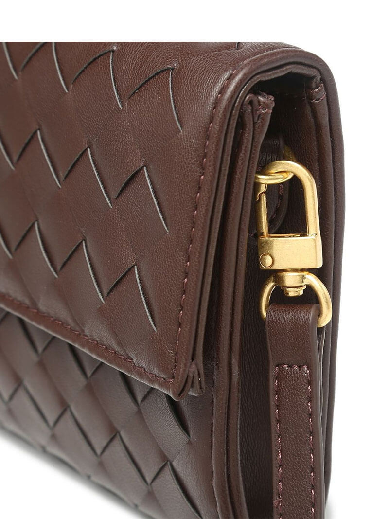 Clutch bag in hand, three-quarter view