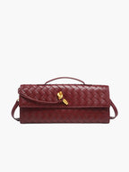 Clutch bag held by top handle, side angle