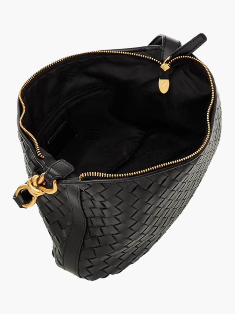 Model wearing woven shoulder bag across body, styled outfit