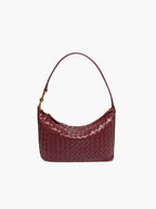 Side profile of structured woven shoulder bag with strap