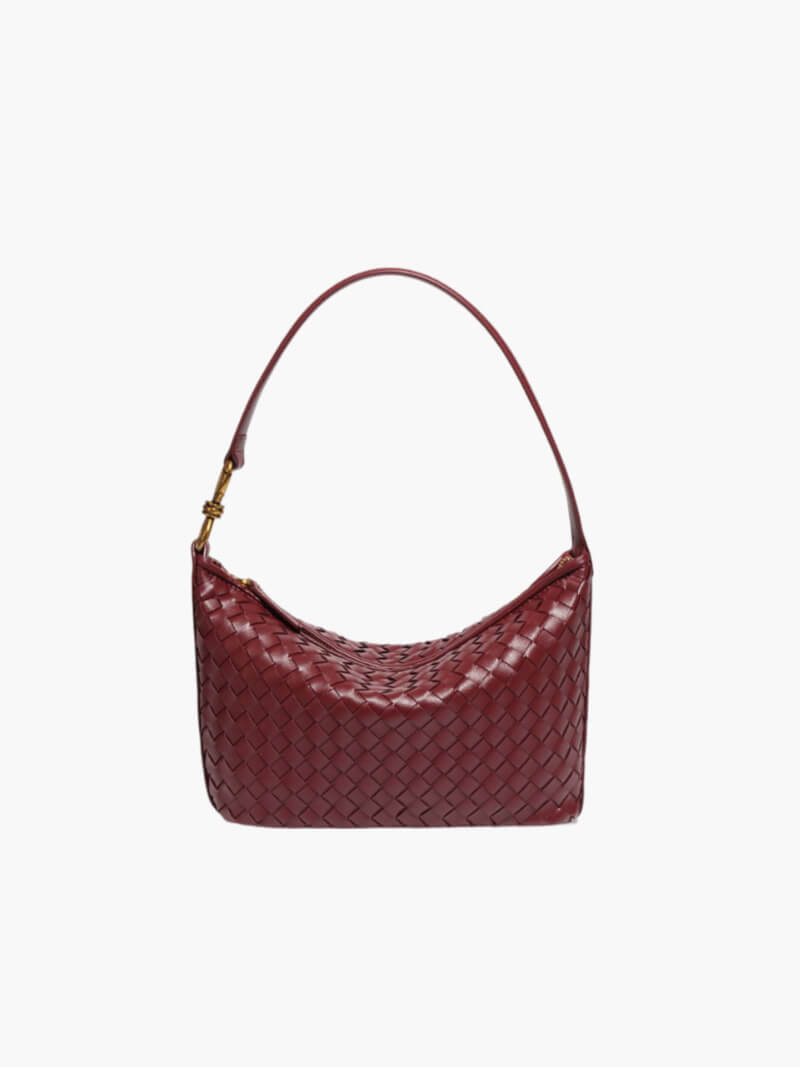 Side profile of structured woven shoulder bag with strap