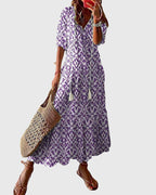 Close-up of ikat print pattern and tassel tie detail on maxi dress