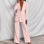 Model in blush pink suit at three-quarter angle