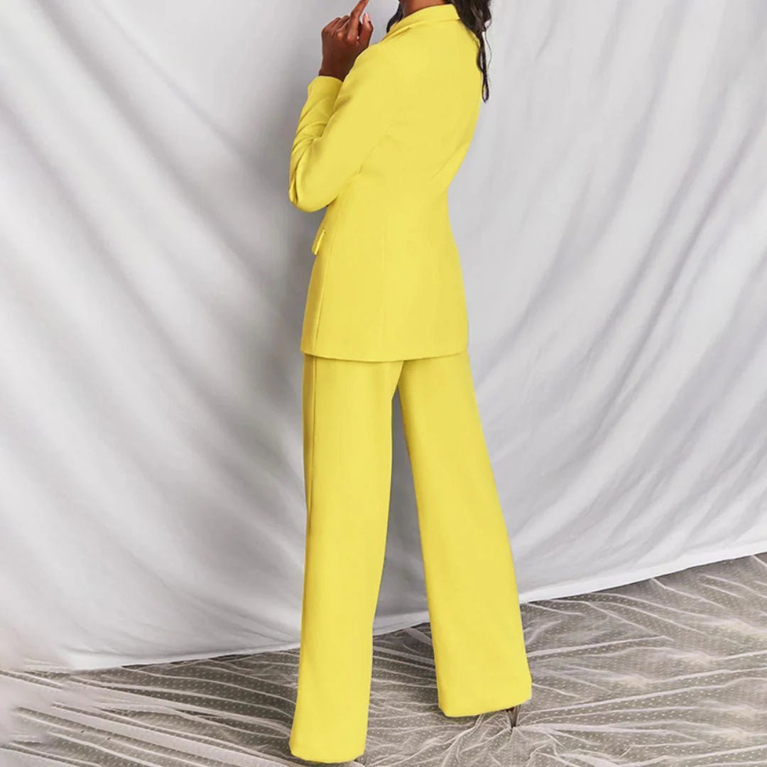 Model walking in blush pink suit, showcasing silhouette