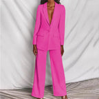 Model seated wearing blush pink suit, demonstrating comfort and movement