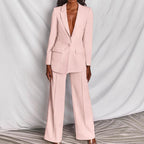 Blush pink tailored suit featuring fitted blazer and wide leg trousers, front view