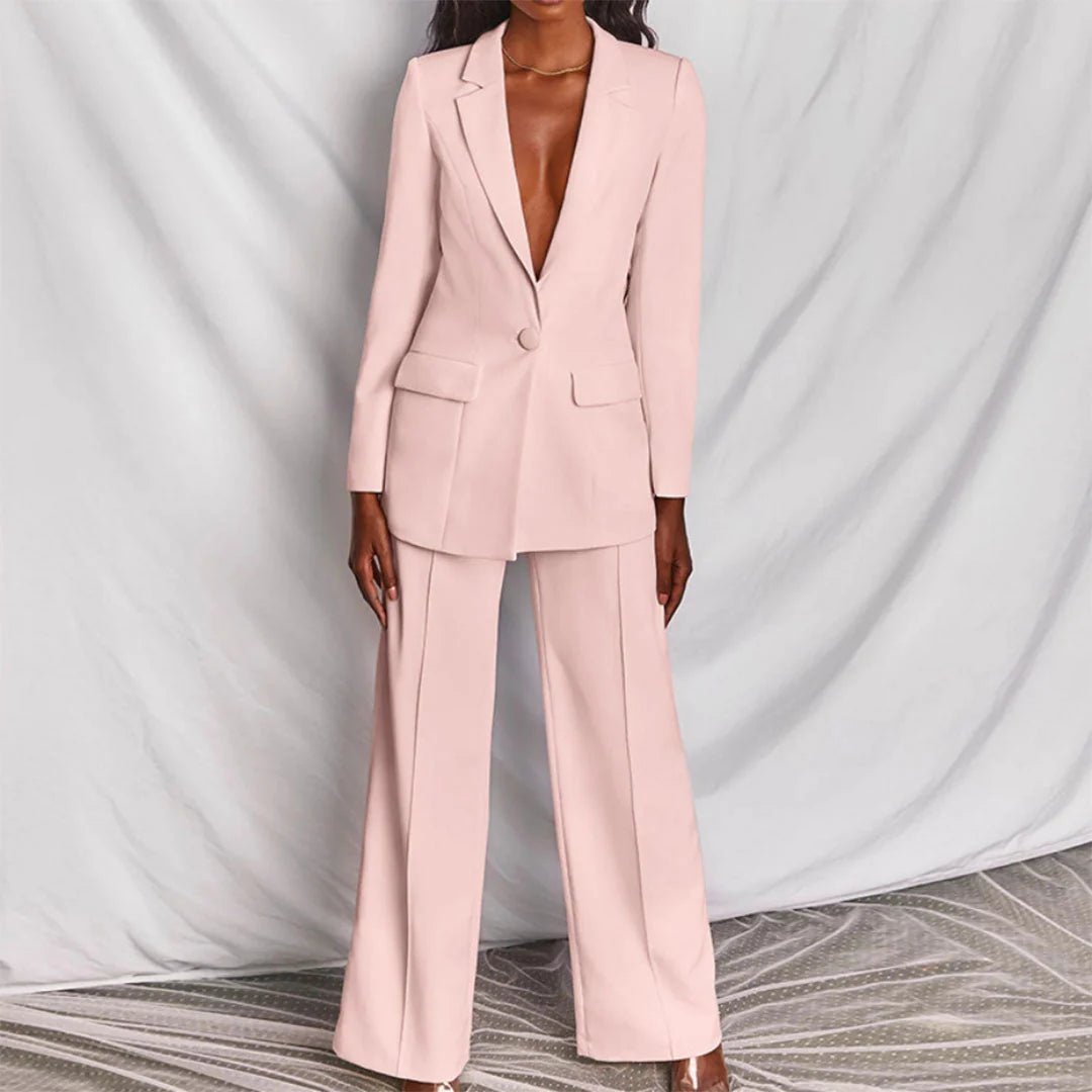 Blush pink tailored suit featuring fitted blazer and wide leg trousers, front view