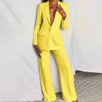 Model wearing blush pink suit, full-length standing pose