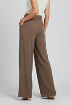 Side profile view of brown palazzo trousers showing leg flow