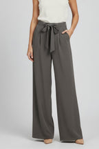 Detail shot of wide leg hem and fabric drape on palazzo trousers