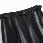 Hem detail of midi length leather skirt