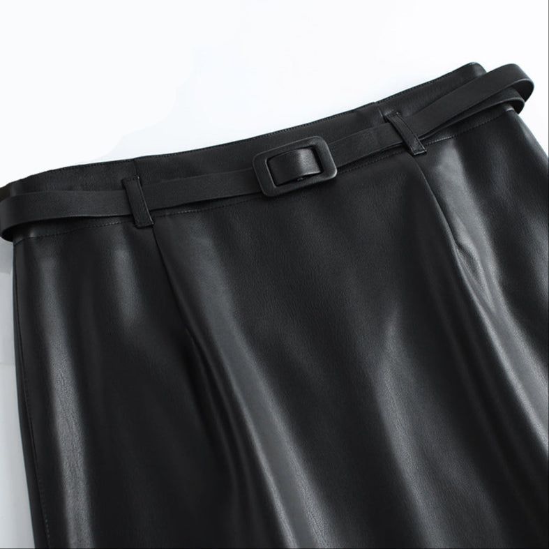 Hem detail of midi length leather skirt
