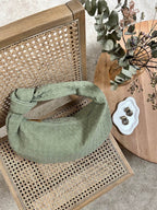 Bottom seam detail of woven faux leather bag