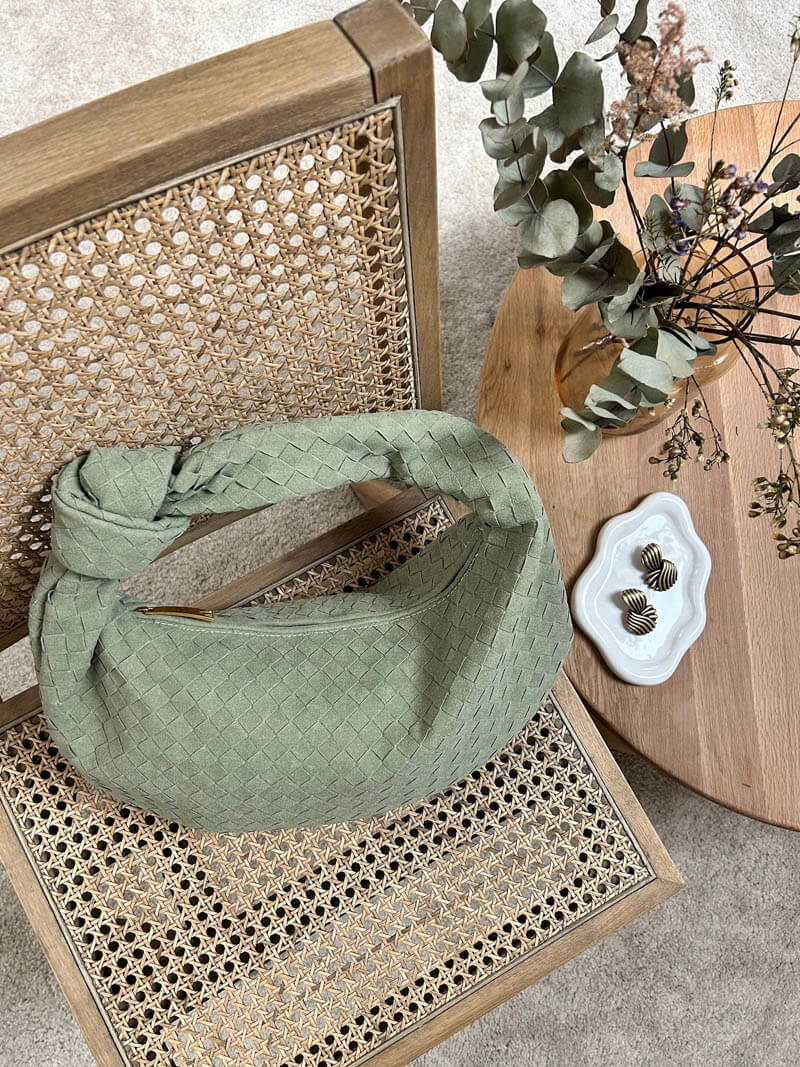 Bottom seam detail of woven faux leather bag