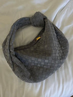 Woven bag flat lay on neutral surface