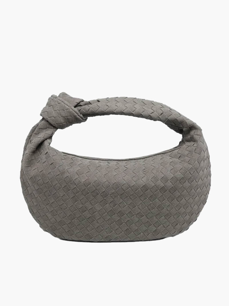 Woven shoulder bag worn crossbody on model, side angle