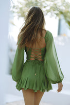 Model wearing wrap dress with voluminous sheer sleeves, full length