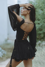 Close-up of gathered bishop sleeve cuffs and cold-shoulder detail