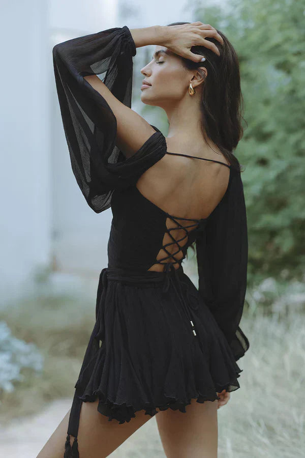 Close-up of gathered bishop sleeve cuffs and cold-shoulder detail