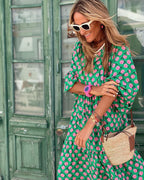 Close-up of pink and white polka dot print on green fabric