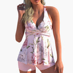 Model wearing tropical leopard tankini from front, showing halter neck and peplum detail