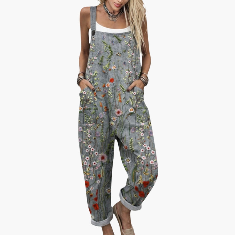 Women wearing grey floral wide leg dungaree jumpsuit with square neckline, front view