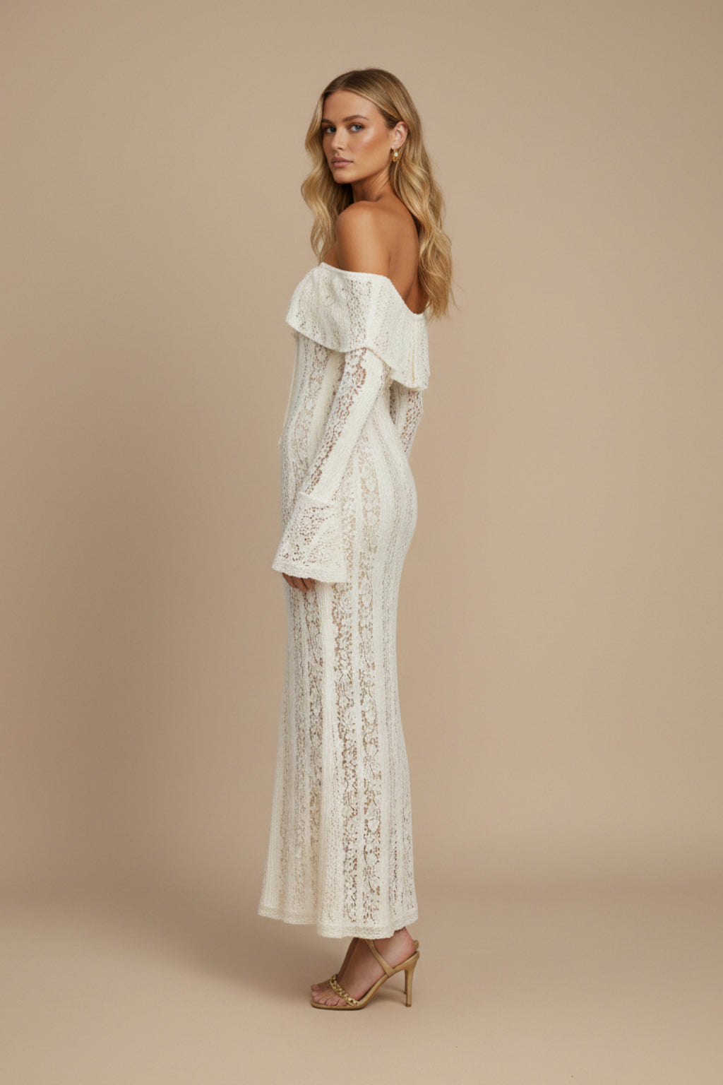 Model wearing ivory lace maxi dress, full-length side profile pose