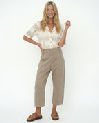 Model wearing wide leg trousers, standing pose