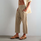 Model wearing trousers, three-quarter length pose