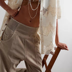 Seated pose wearing wide leg trousers