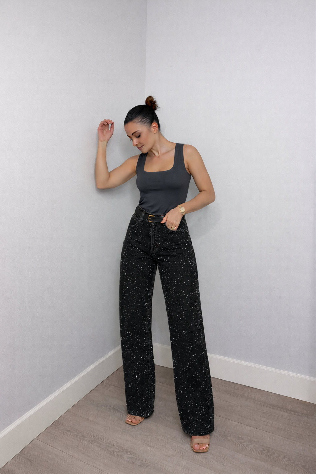 Model wearing high waisted wide leg jeans, full-length side pose