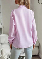 Three-quarter angle shot of model in blouse, turning pose