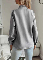 Long sleeve cuff detail on blouse, showing wrist and cuff finish
