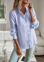 Model in ruffle collar blouse, side profile