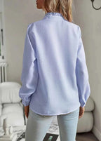 Back view of light blue blouse with long sleeves