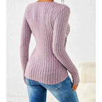 Three-quarter view of lilac top styled with neutral trousers