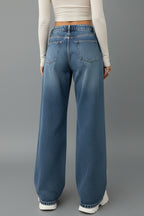 Side view showing contrast stripe detailing on wide leg jeans